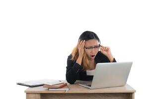 Stressed young business woman at the desk with a laptop isolated on white background. photo