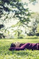 Beautiful young woman lying thinking something photo