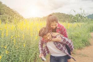 Girlfriend ride back of boyfriend,Girlfriend shoot picture with her boyfriend making good time and enjoying together. photo