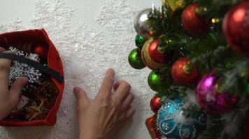 Greeting Season concept.hand setting of ornaments on a Christmas tree with decorative light photo