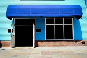 Shopfront vintage store front with canvas awnings and blank display photo