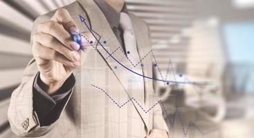 businessman hand draws business success chart photo