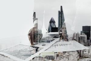 Double exposure of businessman working with new modern computer  and london city blurred background photo