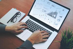 top view of Double exposure of businessman hand working with new modern computer and business strategy and blank book as concept photo