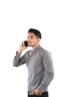 Young hipsterman talking on phone looking away isolated on white background. photo