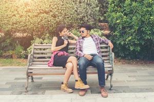Young hipster couple teenagers in love in the city, Summer holiday enjoyment together. photo