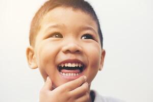 Happy boy laugh looking at camera portrait with isolate white background. photo