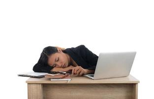 Young business woman tired with her work fall asleep at her desk isolated on white background. photo