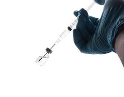 Hand in a blue glove holding syringe isolated on white photo