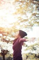 lifestyle concept - beautiful happy woman enjoying fresh air in the park photo