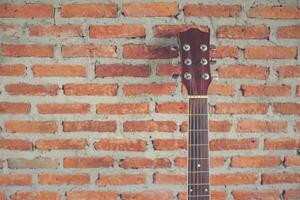 classical guitar with brick background horizontal photo