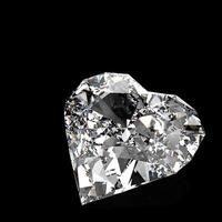 diamond heart shape on black surface photo