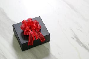 gift giving,a gift box on white gray marble table background photo