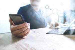 designer using smart phone and keyboard dock digital tablet.Worldwide network connection technology interface.on marble desk,sun flare effect photo