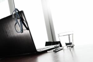 Office workplace with laptop and smart phone on wood table photo