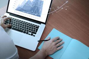 Double exposure of businessman hand working with new modern computer and business strategy as concept photo