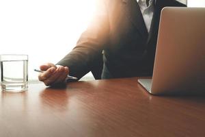 businessman hand working with modern technology as business strategy concept photo