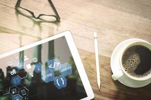 Coffee cup and Digital table dock smart keyboard,eyeglasses,stylus pen on wooden table,filter effect photo