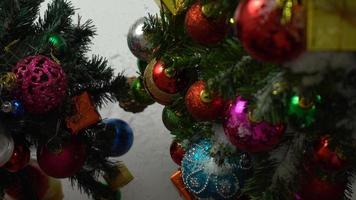 Greeting Season concept.hand setting of ornaments on a Christmas tree with decorative light photo