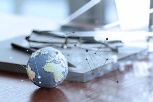 hand drawn texture globe with social media diagram on wood table near note book and glasses photo