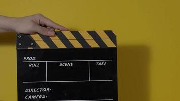 Clapper board. Close up hand and film making clapperboard isolated on background video