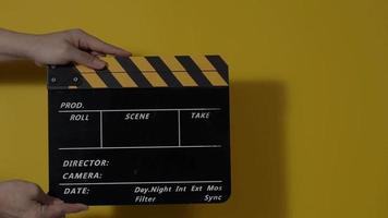 Movie slate or clapperboard hitting. Close up hand holding empty film slate and clapping it. video