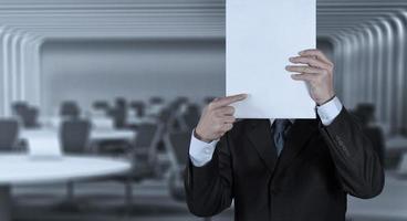 Businessman standing with on blank board photo