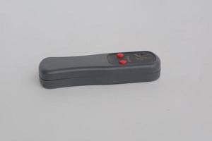 small gray remote on a white background photo