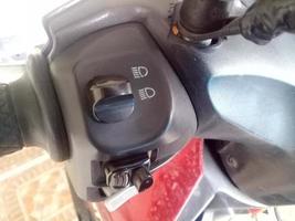 holder with multiple buttons on motorcycle photo