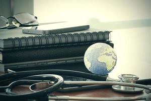 Studio macro of a stethoscope and texture globe with digital tablet with shallow DOF evenly matched abstract as medical network concept photo