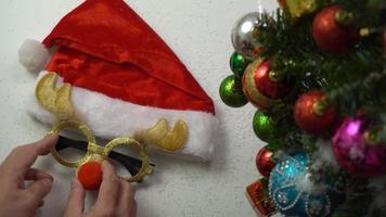 Greeting Season concept.hand setting of ornaments on a Christmas tree with decorative light photo