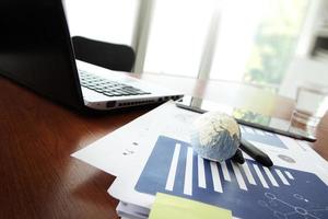 business documents on office table with texture the world on smart phone and digital tablet as work space business concept Elements of this image furnished by NASA photo