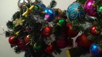 Greeting Season concept.hand setting of ornaments on a Christmas tree with decorative light photo