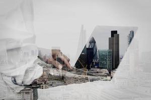 businessman working on his laptop in office with london city background photo