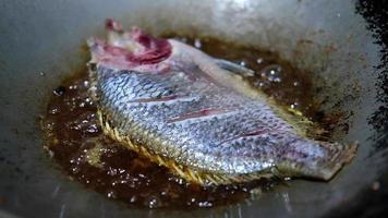 Close up of frying tilapia fish in hot oil. The concept of homemade food