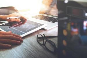 Website designer working digital tablet and computer laptop with digital tablet and digital design diagram on wooden desk and compact server photo