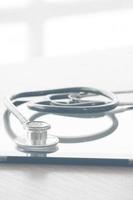 studio macro of a stethoscope and digital tablet on wood table background copy space photo