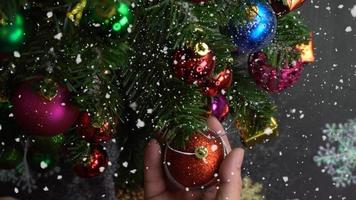 Greeting Season concept.hand setting of ornaments on a Christmas tree with decorative light photo