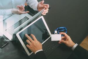 co working team meeting concept,businessman using smart phone and digital tablet and laptop computer and name tag in modern office photo