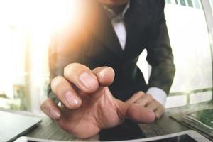 close up of businessman hand working with touch screen computer as concept photo