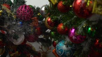 Greeting Season concept.hand setting of ornaments on a Christmas tree with decorative light photo