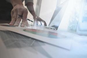 business documents on office table with smart phone and laptop computer and graph business with social network diagram and man working in the background photo