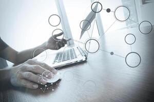 Doctor working with laptop computer in medical workspace office and medical network media diagram as concept photo