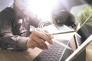 Outsource Developer working on marble Desk Working Laptop Computer Mobile Application Software and digital tablet dock smart keyboard,compact server,sun flare effect photo