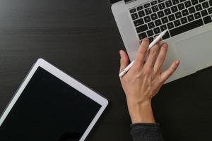 cyber security internet and networking concept.Businessman hand working with laptop computer and digital tablet photo