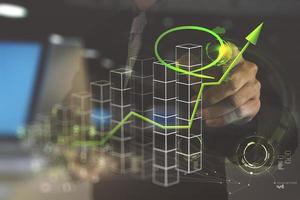 double exposure of businessman hand drawing a pie chart photo