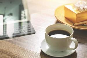 Coffee cup and Digital table dock smart keyboard,gold gift box and round wood tray,color pencil on wooden table,filter effect photo