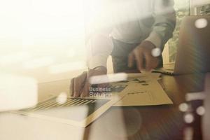 double exposure of new modern laptop computer with businessman hand working and business strategy as concept photo