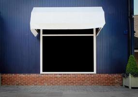 Shopfront vintage store front with canvas awnings and blank display photo