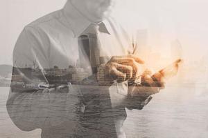Double exposure of success businessman using smart phone with London building,city,front view,filter effect photo